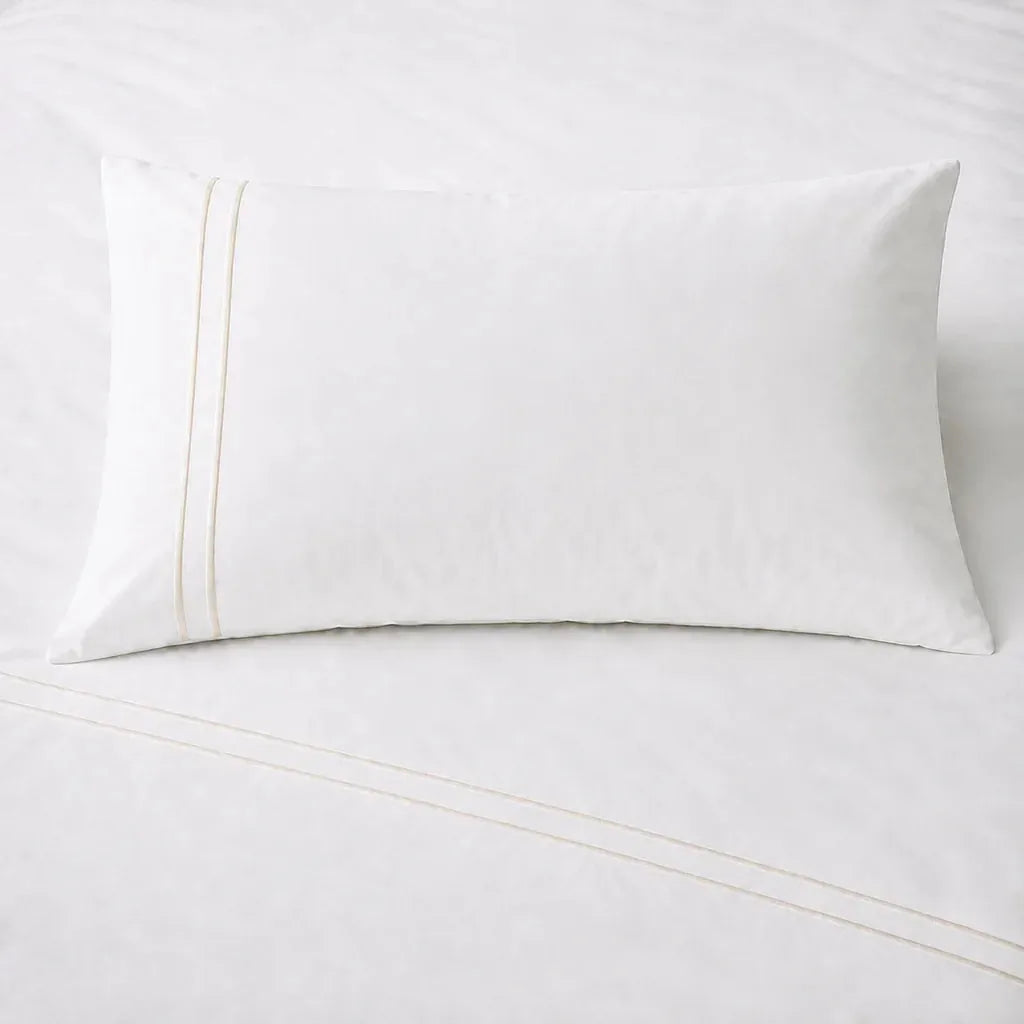 White 200TC plain duvet cover with Cream two row satin stitch - on the bed - Linen and Co