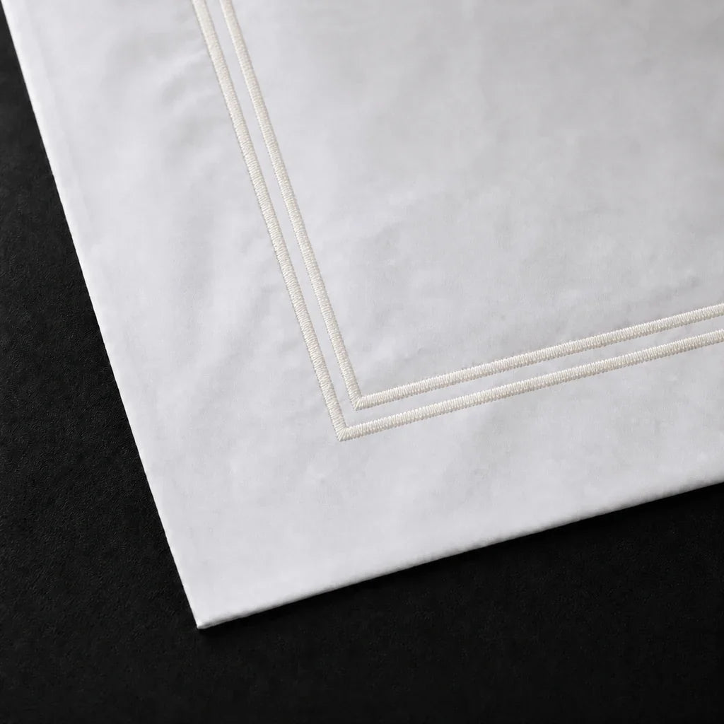 Close-up of a White 100% cotton percale 300TC Oxford pillow case with Cream two-row satin stitch.