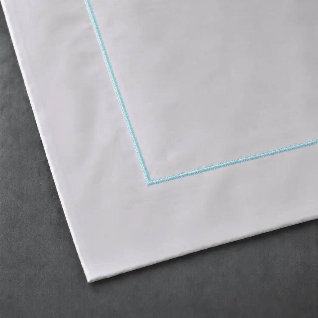 Close-up of a White 100% cotton percale 300TC Oxford pillow case with Duck Egg one-row satin stitch.