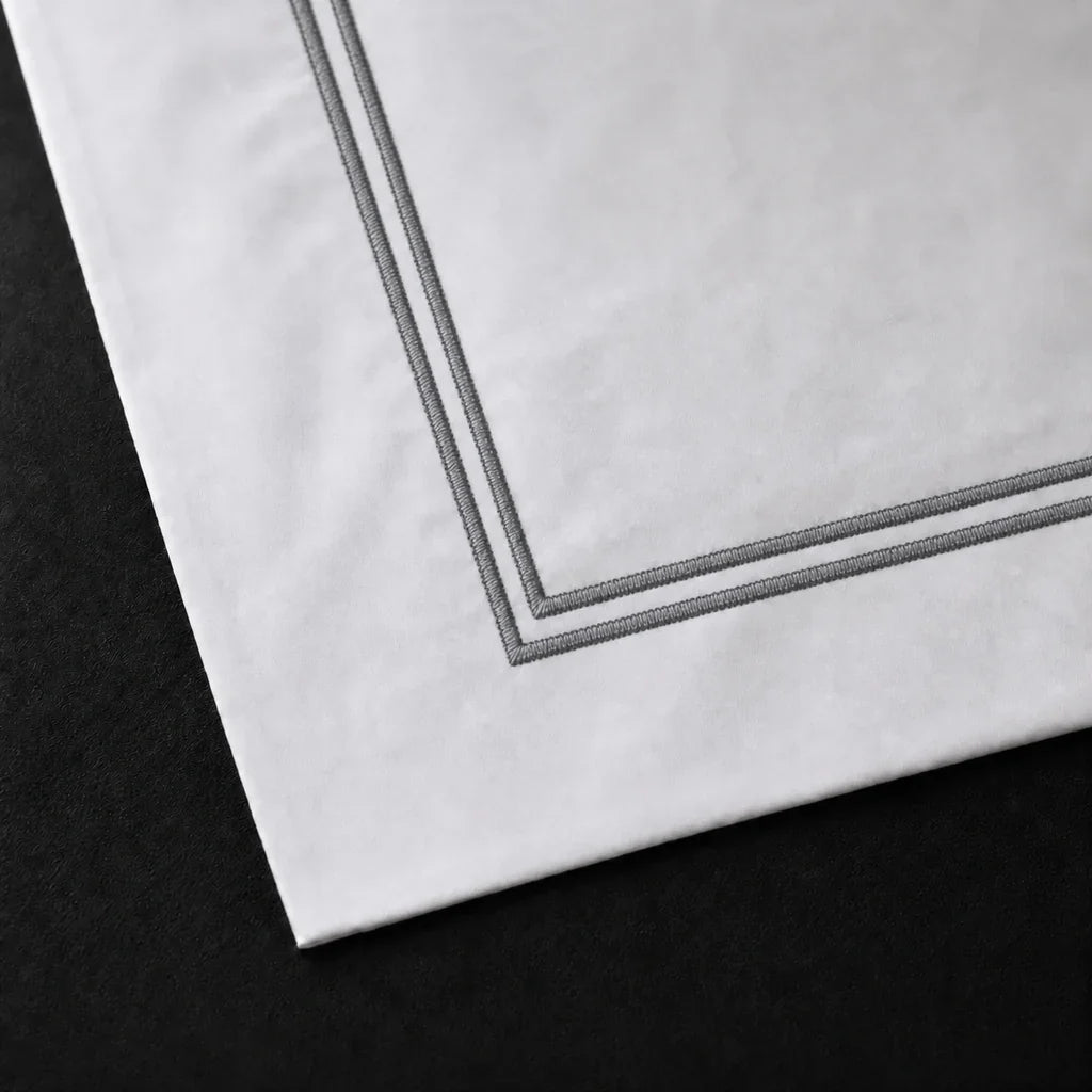 Close-up of a White 100% cotton percale 300TC Oxford pillow case with Grey two-row satin stitch.