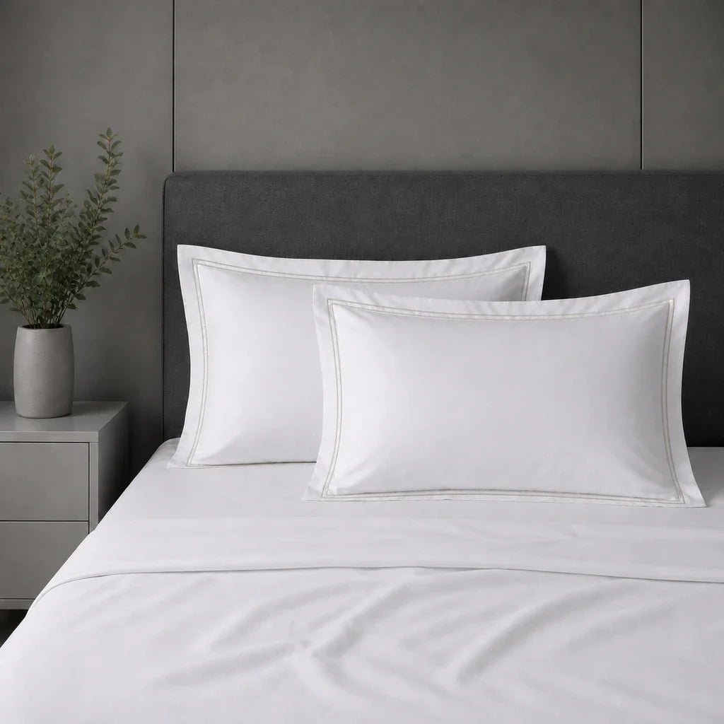 White 100% cotton percale 300TC Oxford pillow cases on a bed with Stone two-row satin stitch.