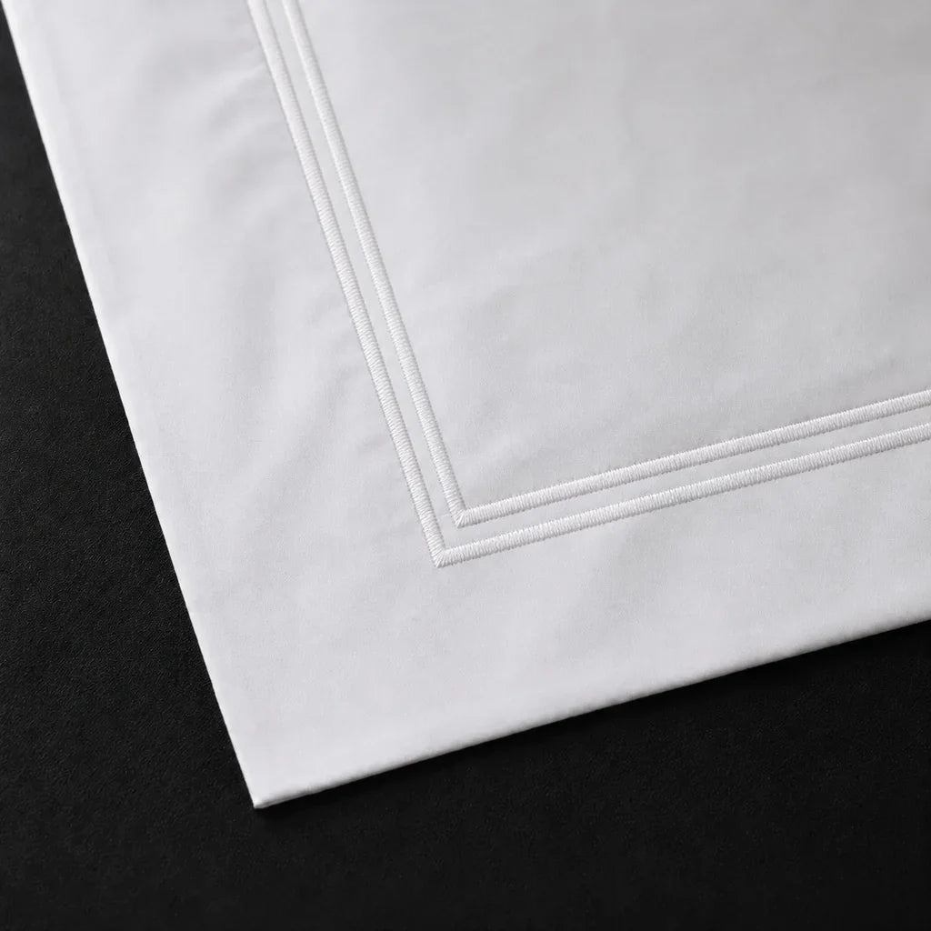Close-up of a White 100% cotton percale 300TC Oxford pillow case with White two-row satin stitch.