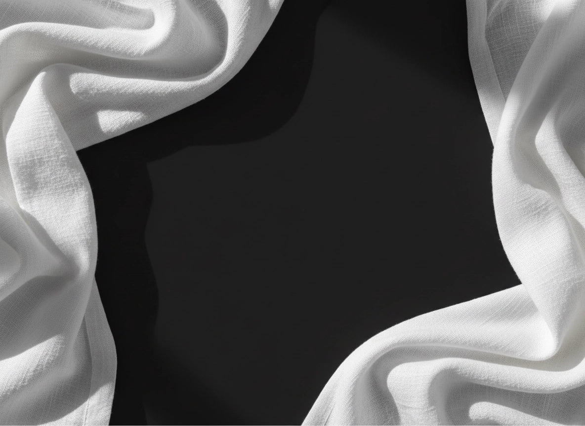 Close-up of white linen fabric texture and drape by Linen and Co - custom sizing guide for luxury bedding
