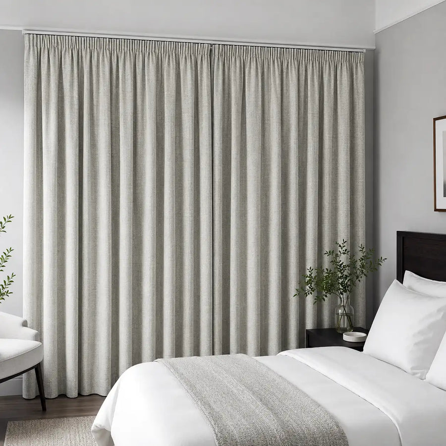 Linen blockout curtains create a restful, hotel-ready bedroom with warm neutral texture.