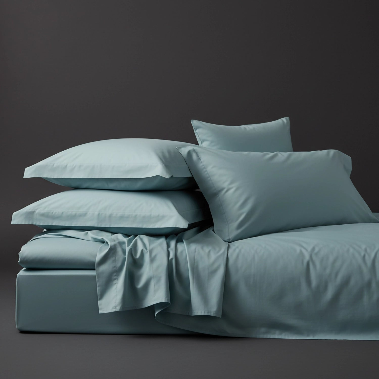 Duck Egg percale bed linen and pillowcases by Linen and Co, stacked to showcase crisp, premium bedding for hospitality and home.