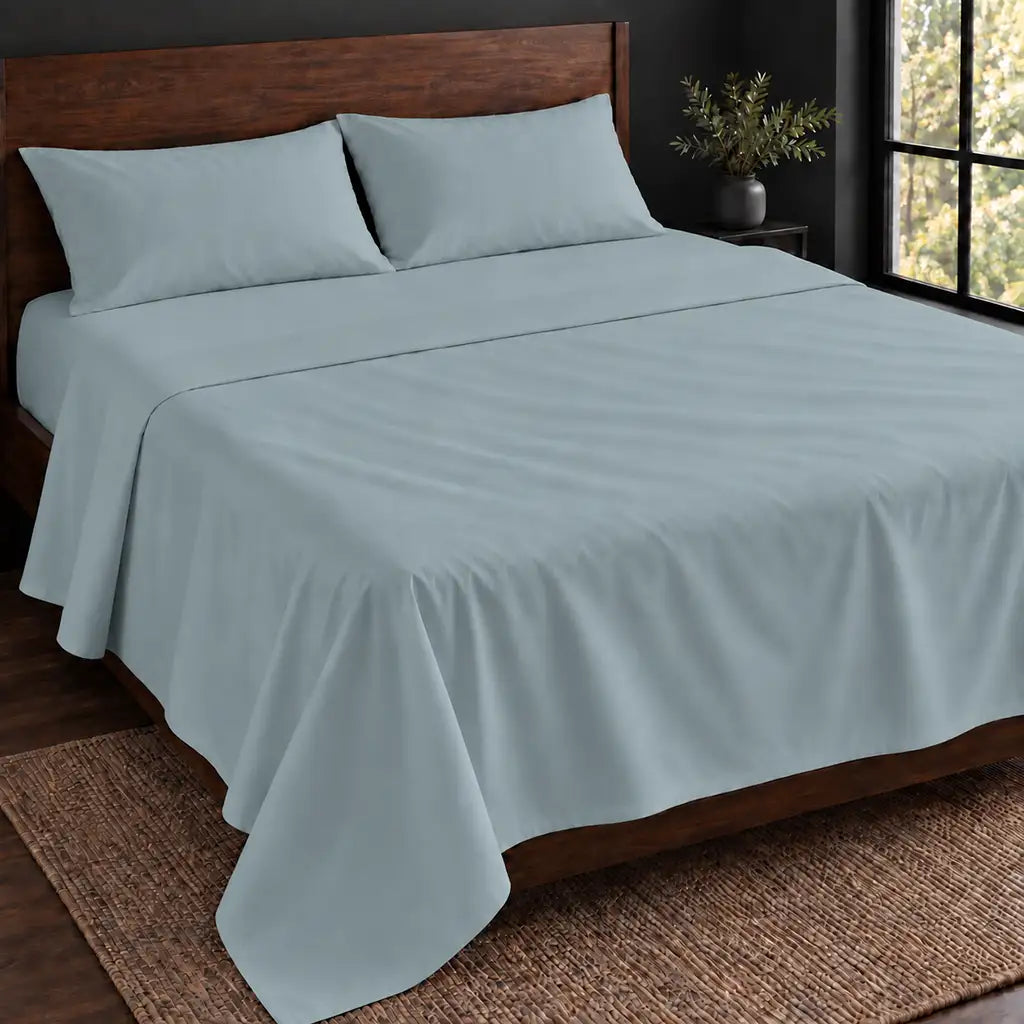 Duck Egg Polycotton Percale 200TC flat sheet, plain no satin stitch — hero on the bed — Linen and Co.