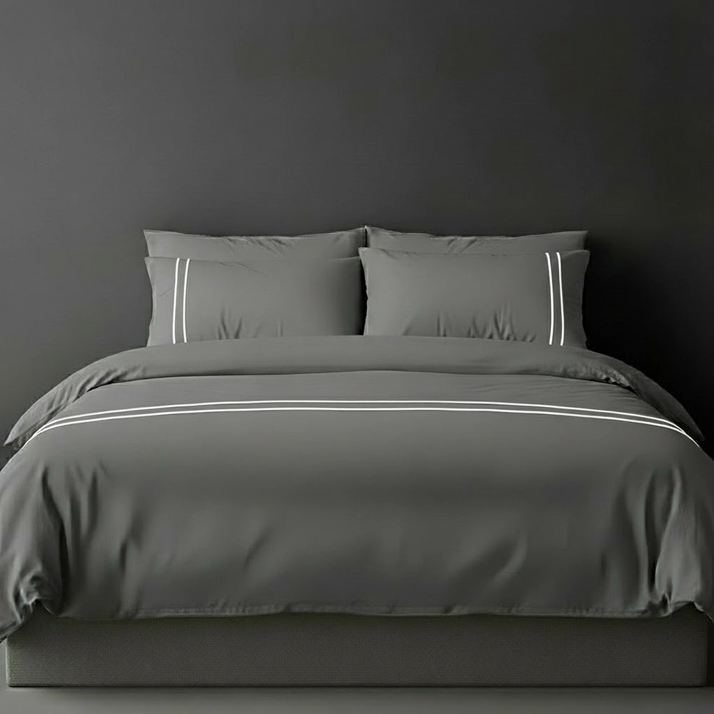Grey duvet cover with white satin stitch and pillows by Linen and Co - luxury bed linen