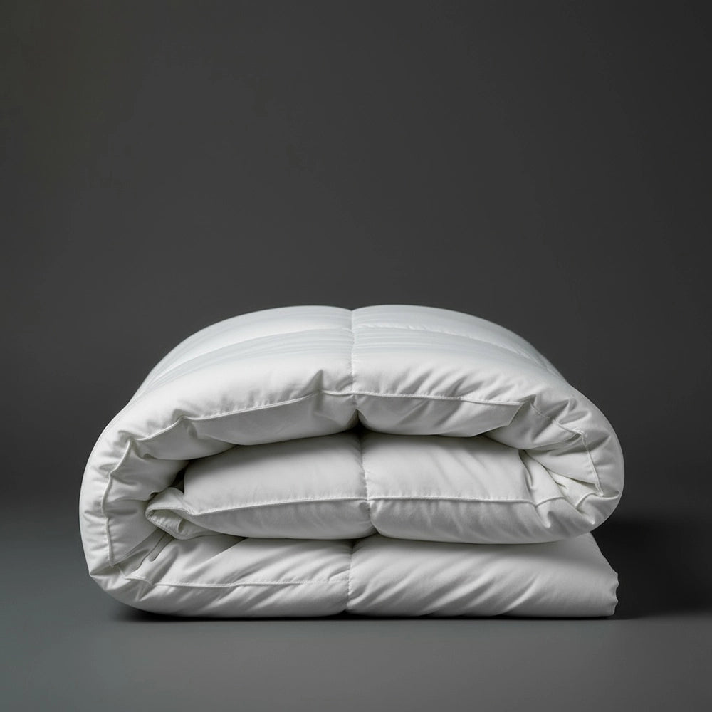 Folded white natural cotton summer duvet inner on dark grey background—lightweight, breathable cotton duvet by Linen & Co