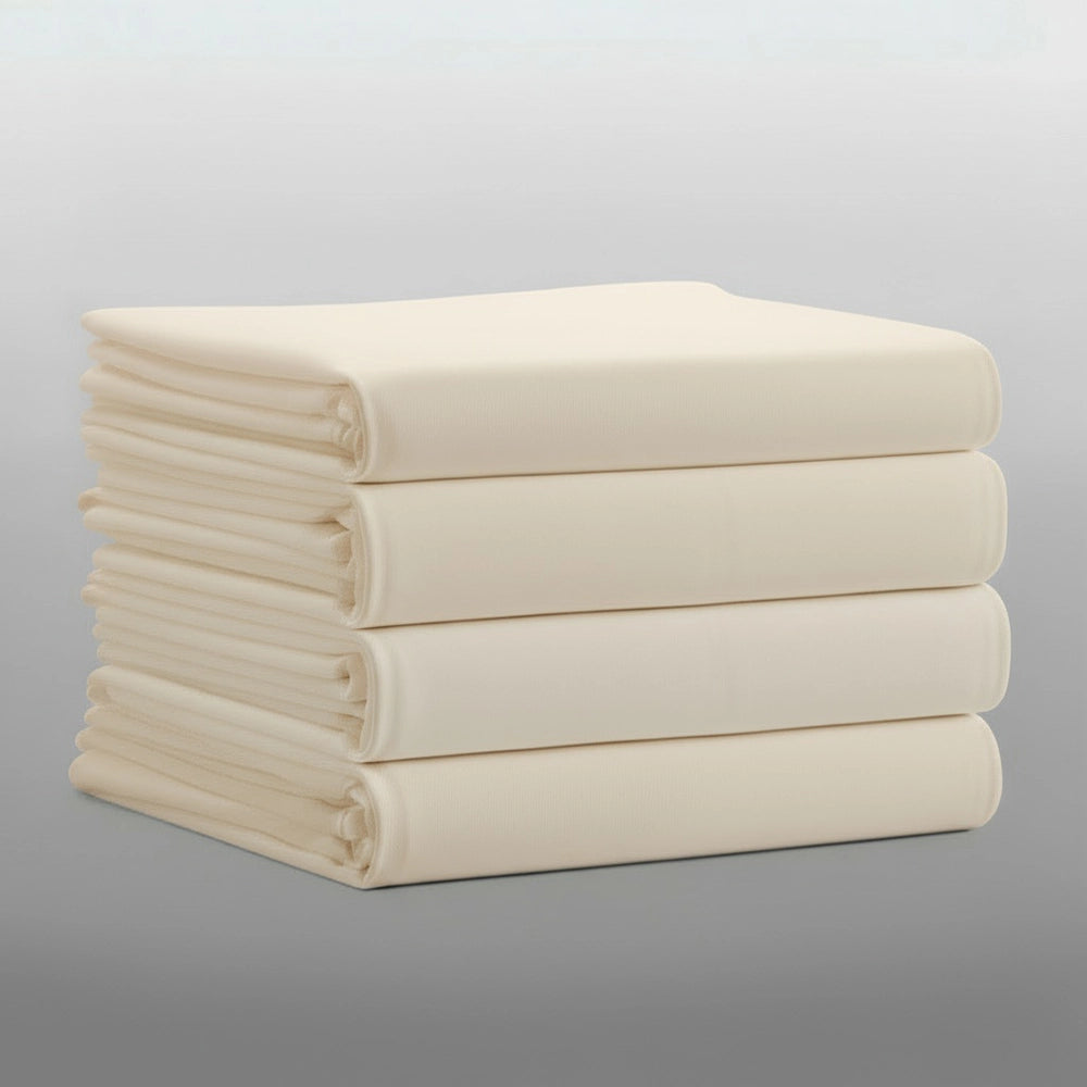 Stack of folded cream percale 200TC flat sheets on light grey background—durable, colour-fast flat sheets by Linen & Co