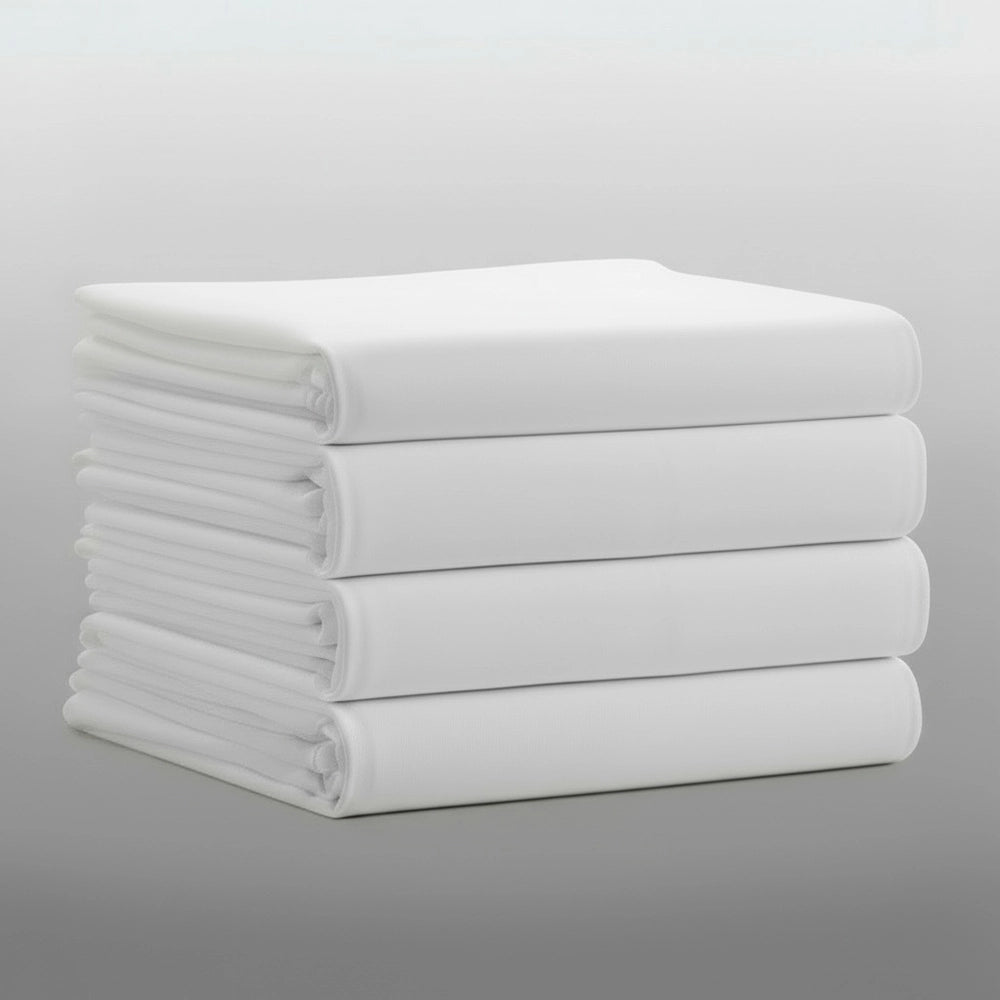 Stack of folded white percale 200TC flat sheets on light grey background—durable, colour-fast flat sheets by Linen & C