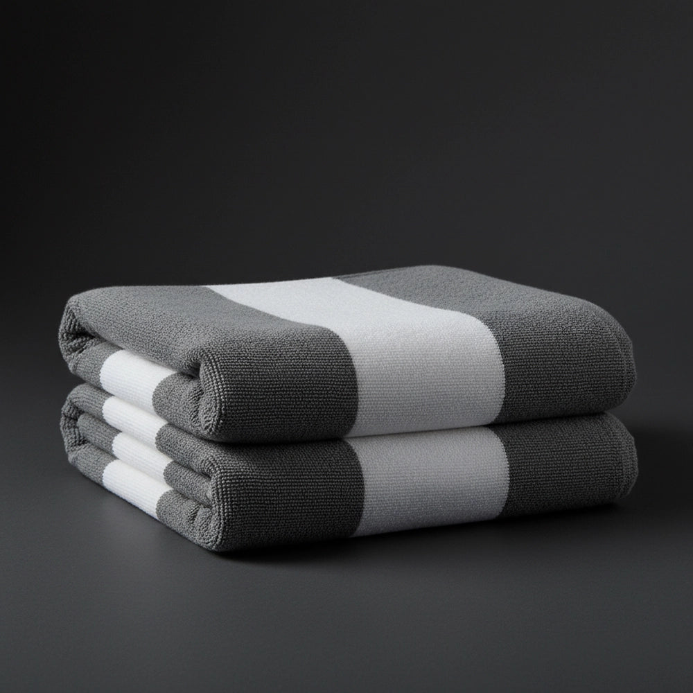 Grey and white broad stripe pool towels stacked - premium hospitality pool linen by Linen and Co