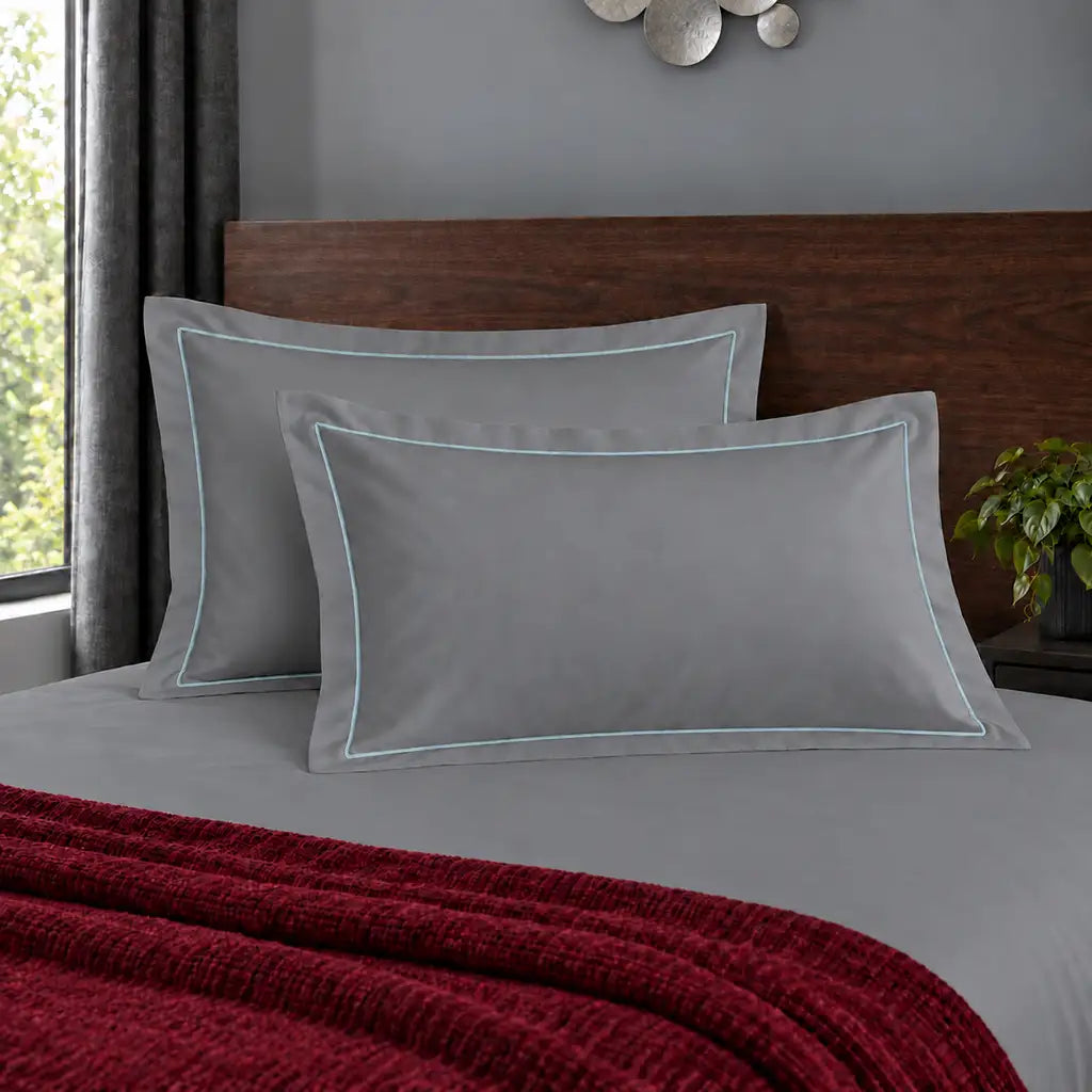 Oxford grey 200TC polycotton percale pillowcases with one row duck egg satin stitch border by Linen and Co