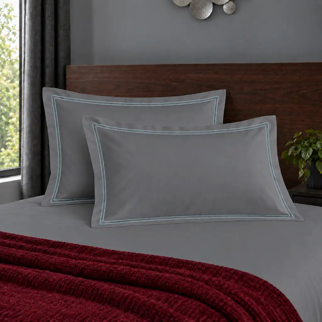 Oxford grey 200TC polycotton percale pillowcases with two row duck egg satin stitch border by Linen and Co
