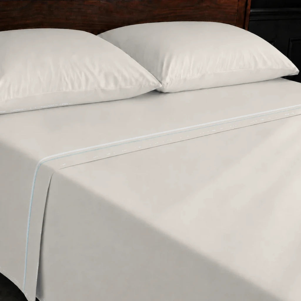 Ivory Cream 100% Cotton Percale 200TC flat sheet with Duck Egg one-row satin stitch - on the bed - Linen and Co