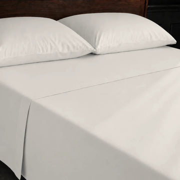 Ivory Cream 100% Cotton Percale 200TC flat sheet with no satin stitch - on the bed - Linen and Co
