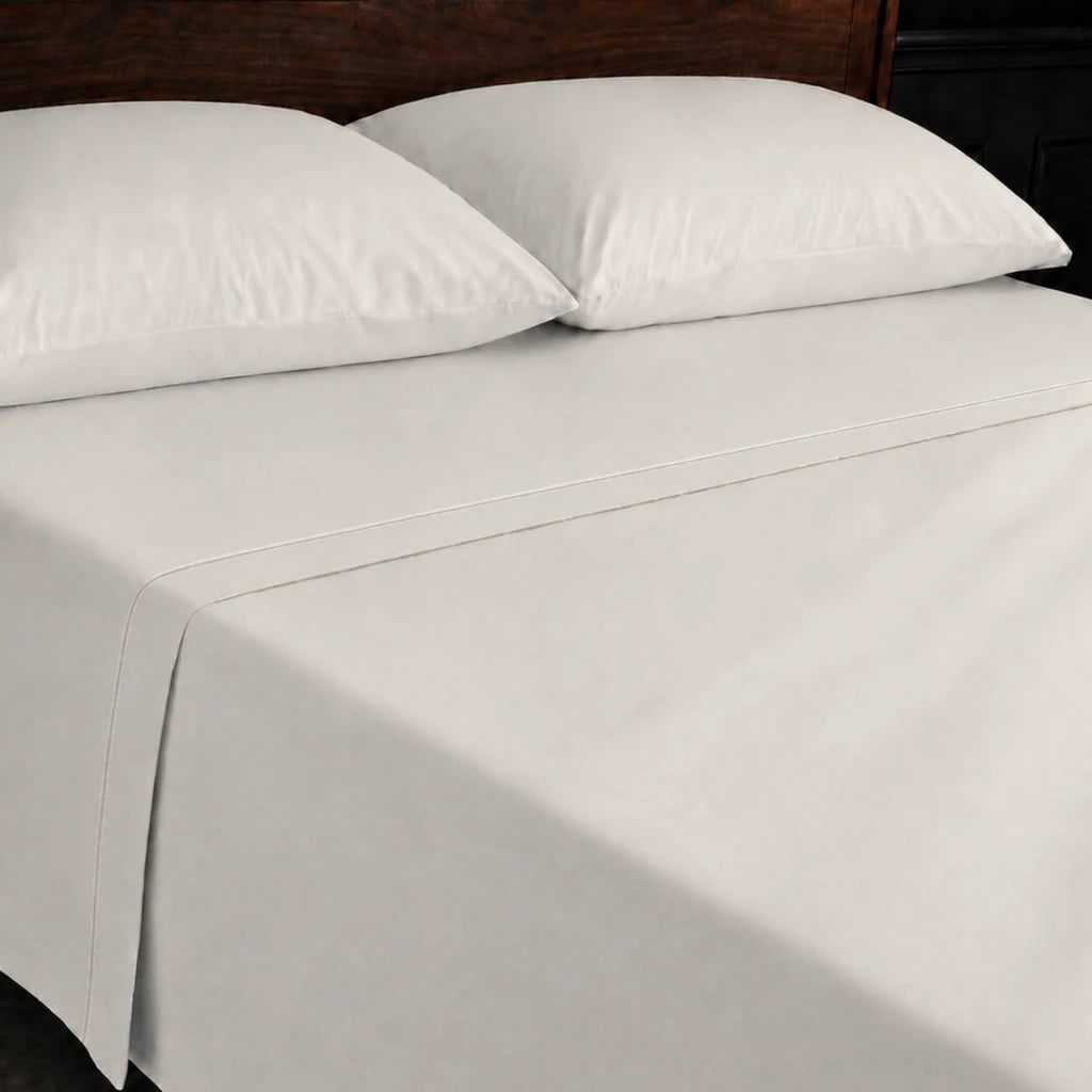 Ivory Cream 100% Cotton Percale 200TC flat sheet with Stone one-row satin stitch - on the bed - Linen and Co