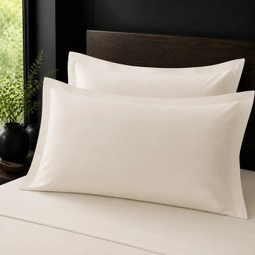 Ivory Cream 100% Cotton Percale 200TC Oxford pillow cases on a bed with no satin stitch - Linen and Co