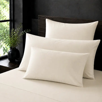 Cream 100% Cotton Percale 200TC plain pillow cases with no satin stitch - on the bed - Linen and Co