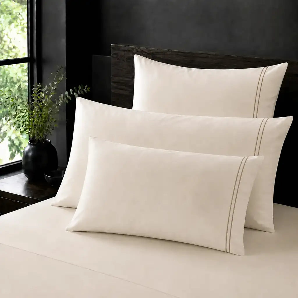 Cream 100% Cotton Percale 200TC plain pillow cases with Stone two-row satin stitch - on the bed - Linen and Co