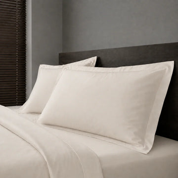 Ivory Cream Polycotton Percale 200TC Oxford pillow cases on a bed with no satin stitch - Linen and Co