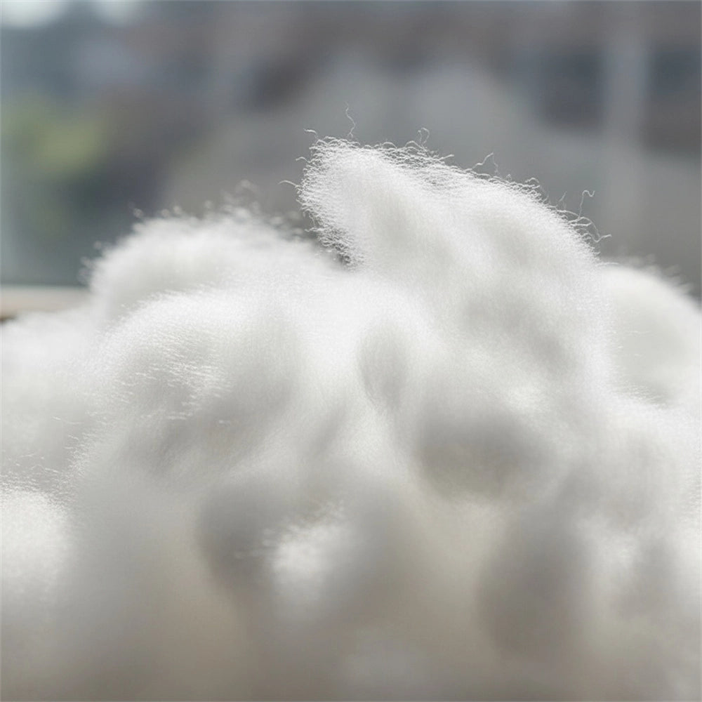 Close-up macro texture of soft white luxury microfibre fabric showing fine filament weave and breathable material quality—hypoallergenic duvet inner and bedding by Linen & Co