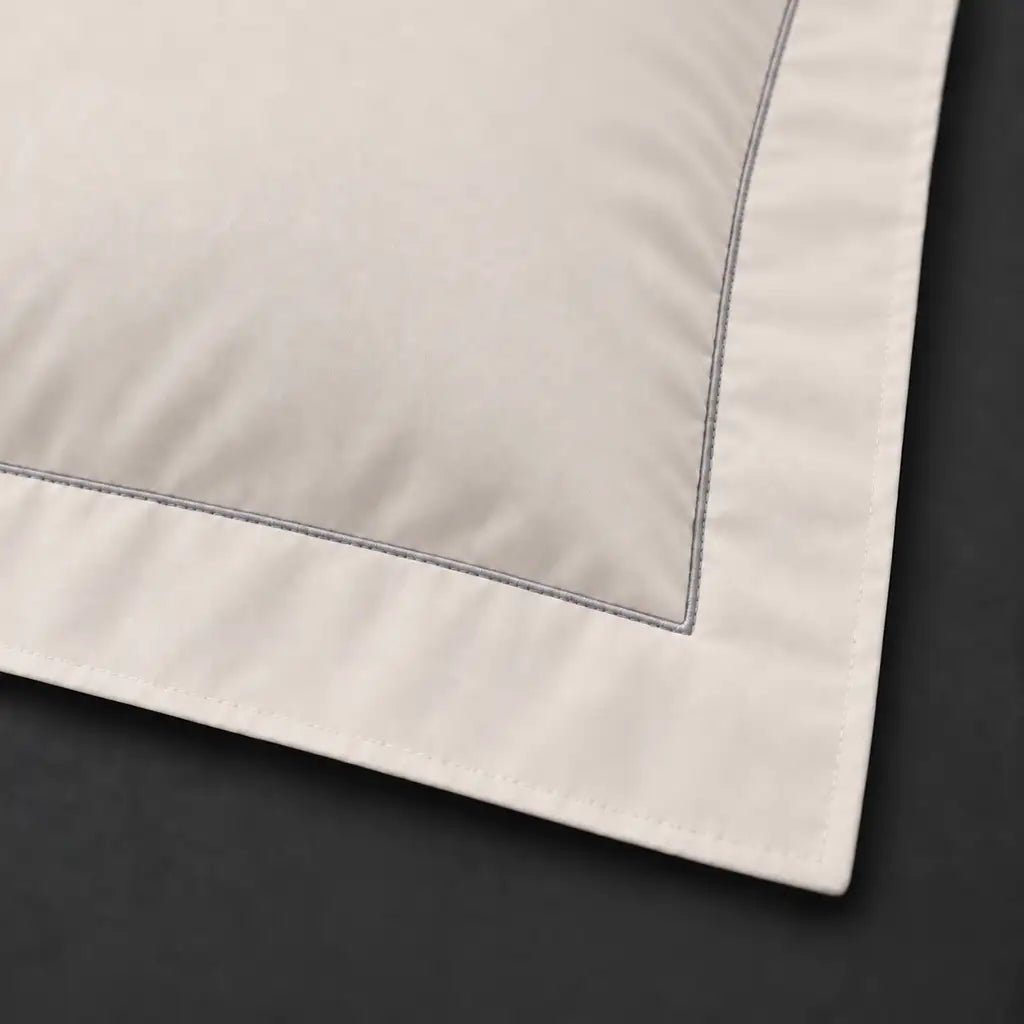 Close-up of cream Oxford pillowcase with one row grey satin stitch border by Linen and Co