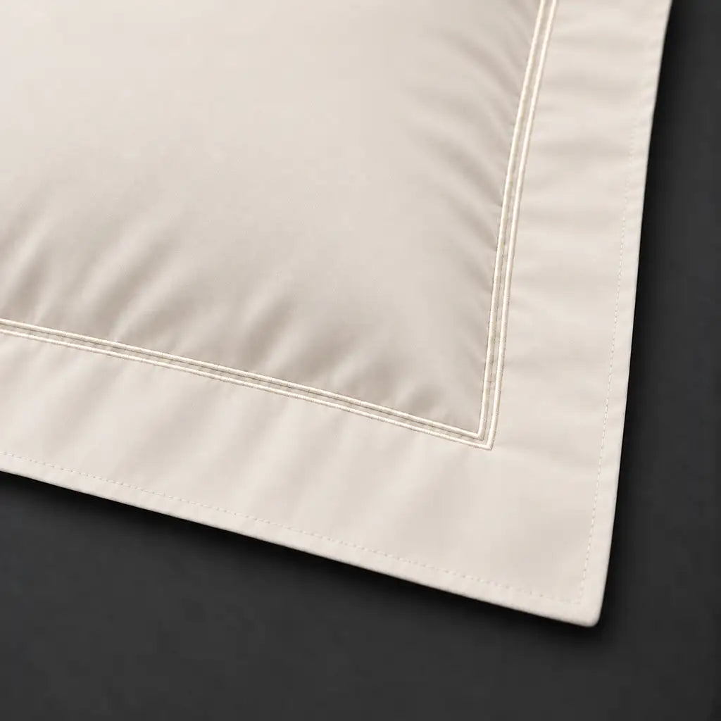 Close-up of cream Oxford pillowcase with two row cream satin stitch border by Linen and Co