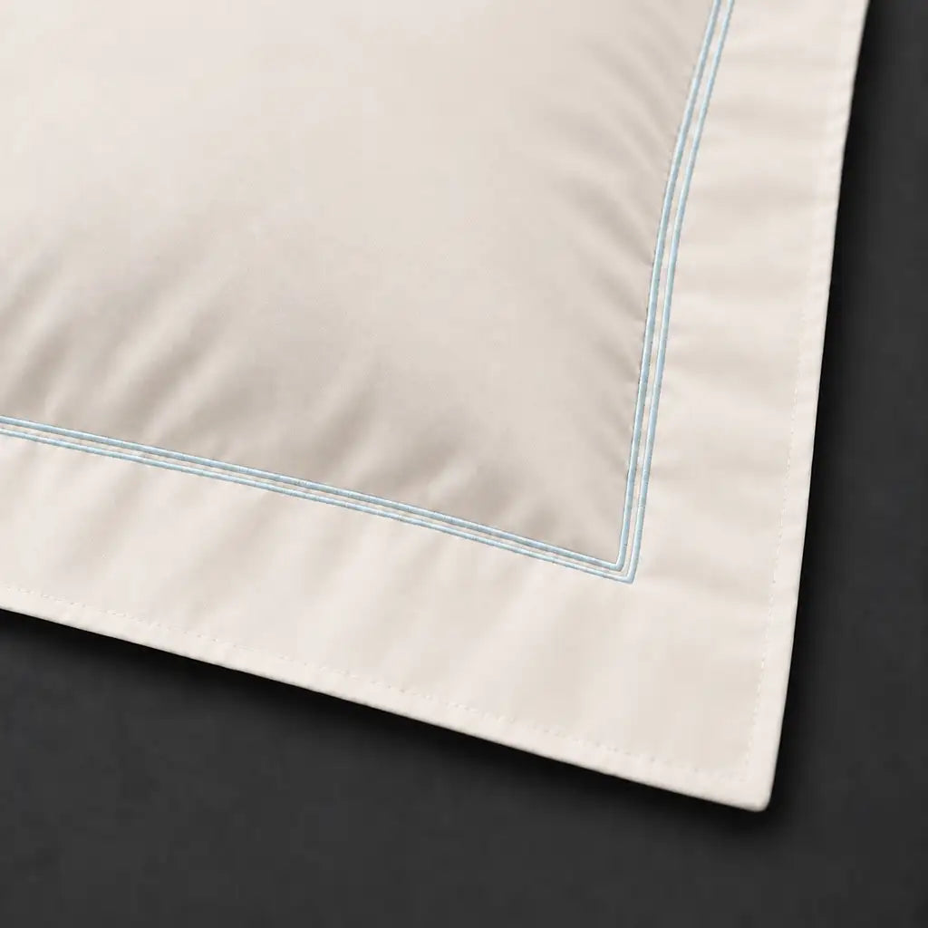 Close-up of cream Oxford pillowcase with two row duck egg satin stitch border by Linen and Co