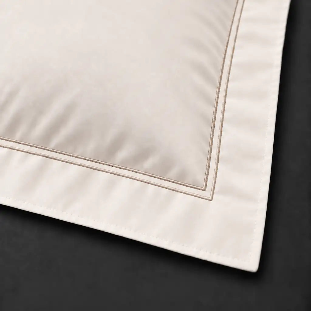 Close-up of cream Oxford pillowcase with two row stone satin stitch border by Linen and Co