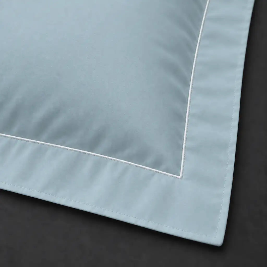 Close-up of duck egg Oxford pillowcase with one row white satin stitch border by Linen and Co