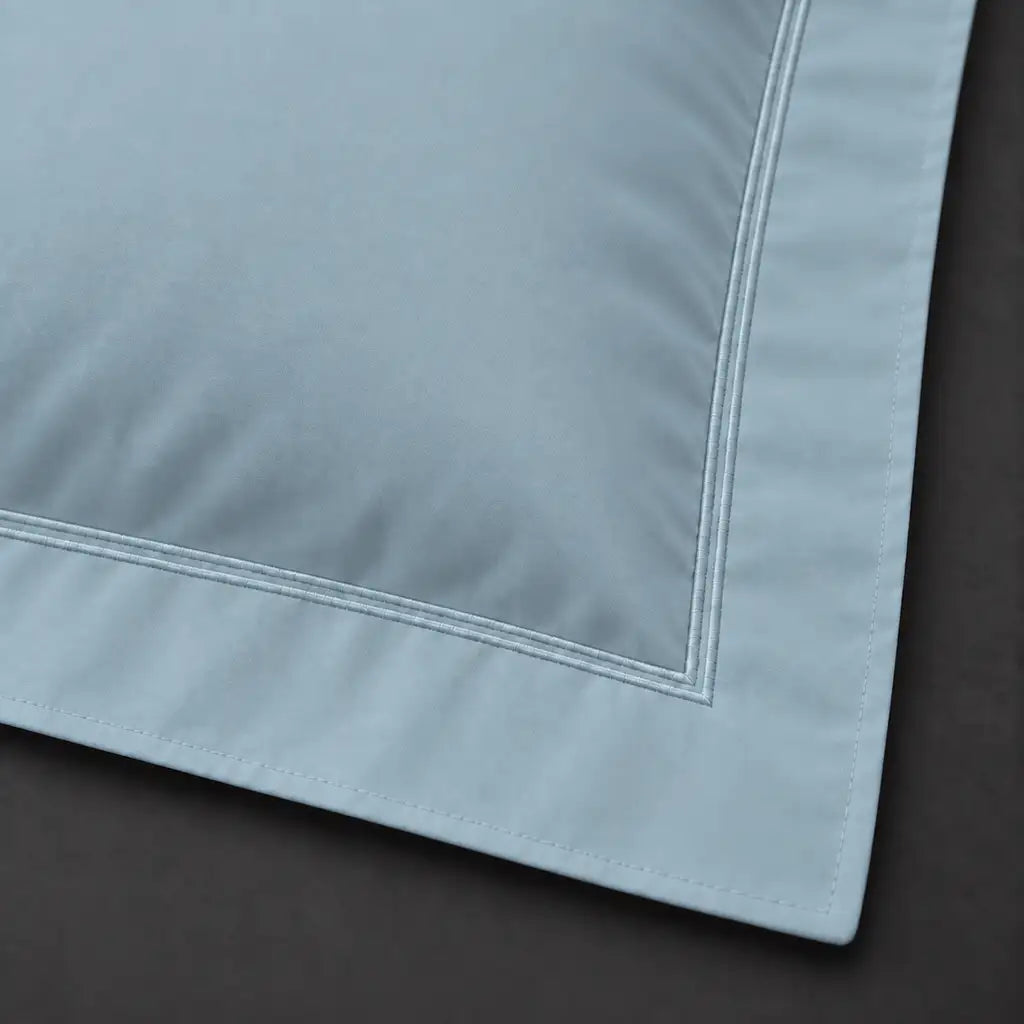 Close-up of duck egg Oxford pillowcase with two row duck egg satin stitch border by Linen and Co