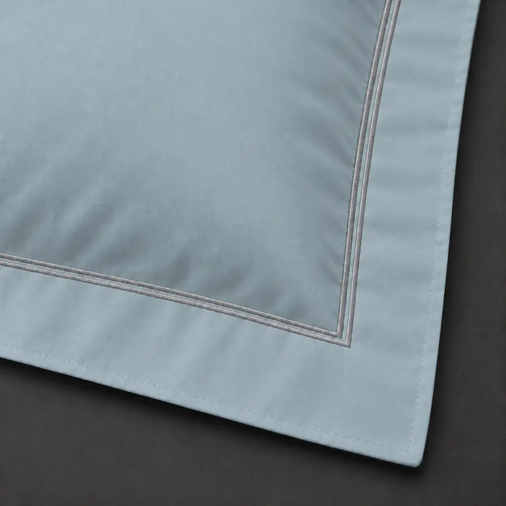 Close-up of duck egg Oxford pillowcase with two row grey satin stitch border by Linen and Co