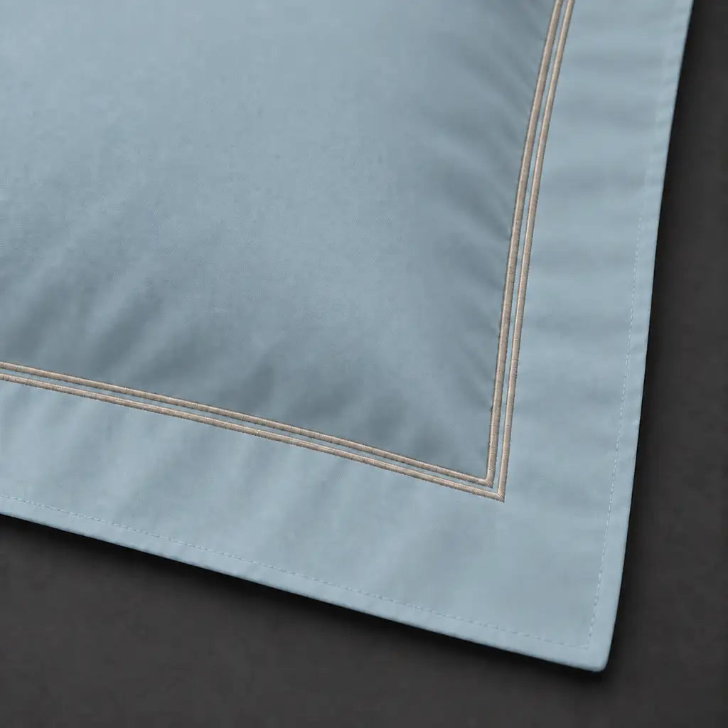 Close-up of duck egg Oxford pillowcase with two row stone satin stitch border by Linen and Co