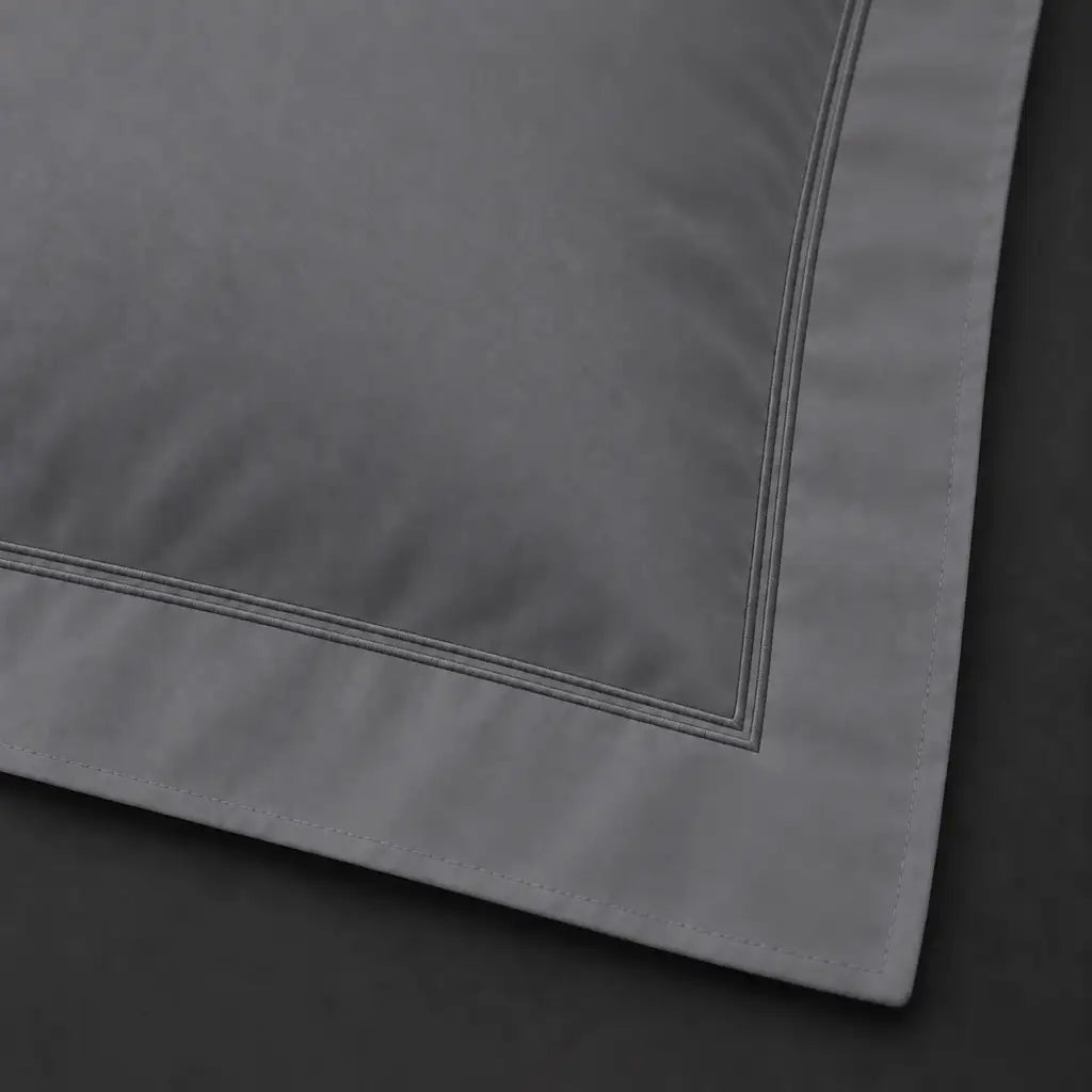 Close-up of grey Oxford pillowcase with two row grey satin stitch border by Linen and Co
