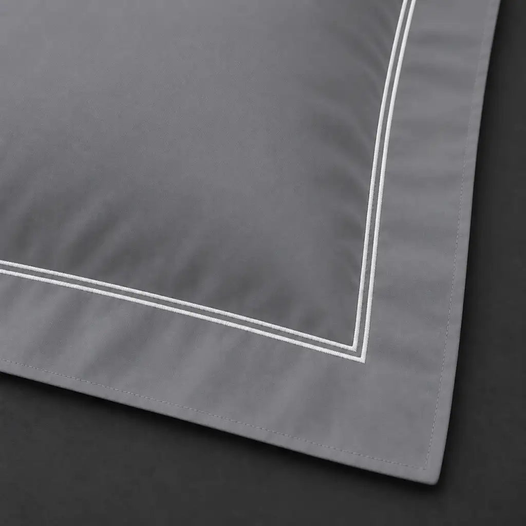 Close-up of grey Oxford pillowcase with two row white satin stitch border by Linen and Co