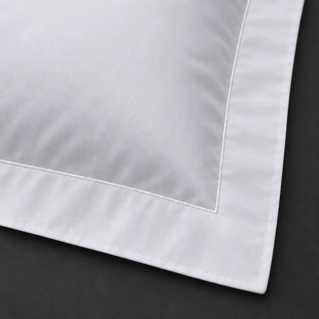 Close-up of white Oxford pillowcase with one row white satin stitch border by Linen and Co