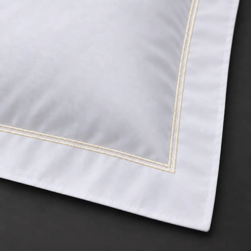 Close-up of white Oxford pillowcase with two row cream satin stitch border by Linen and Co