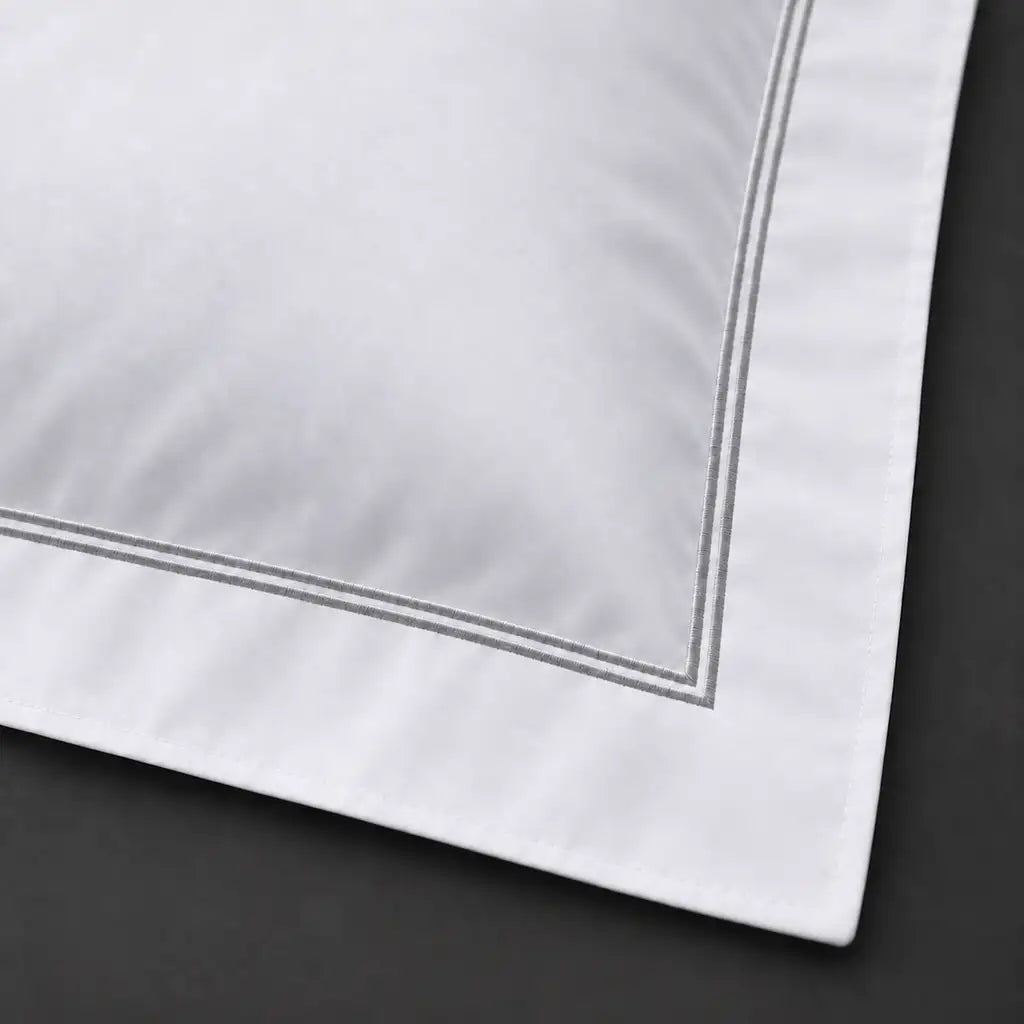 Close-up of white Oxford pillowcase with two row grey satin stitch border by Linen and Co
