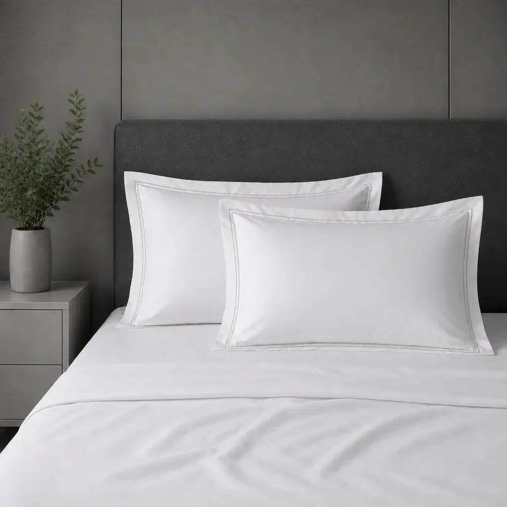 White polycotton percale 200TC Oxford pillow cases on a bed with Stone two-row satin stitch.