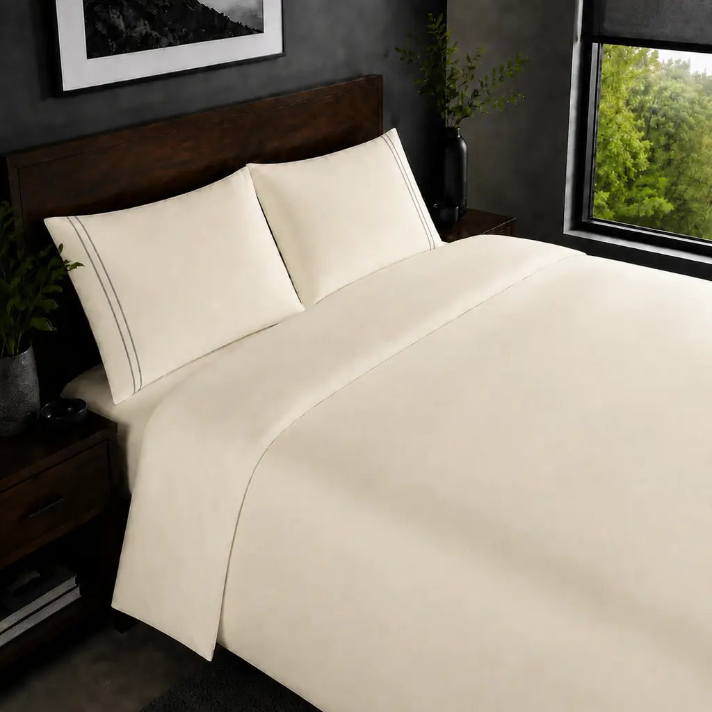 Cream 200TC plain duvet cover with Grey two row satin stitch - on the bed - Linen and Co