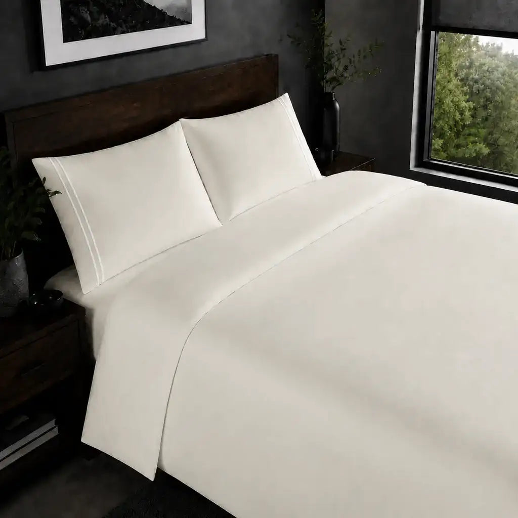 Cream 200TC plain duvet cover with White two row satin stitch - on the bed - Linen and Co