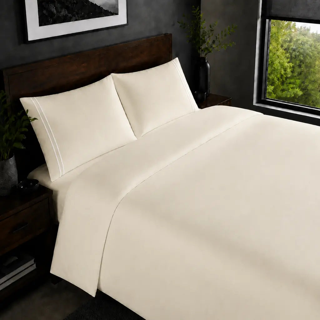 Cream 200TC plain duvet cover with White two row satin stitch - on the bed - Linen and Co