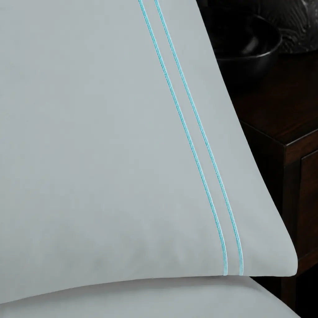 Close-up of Duck Egg two-row satin stitch on the Duck Egg Polycotton Percale 200TC duvet cover set.