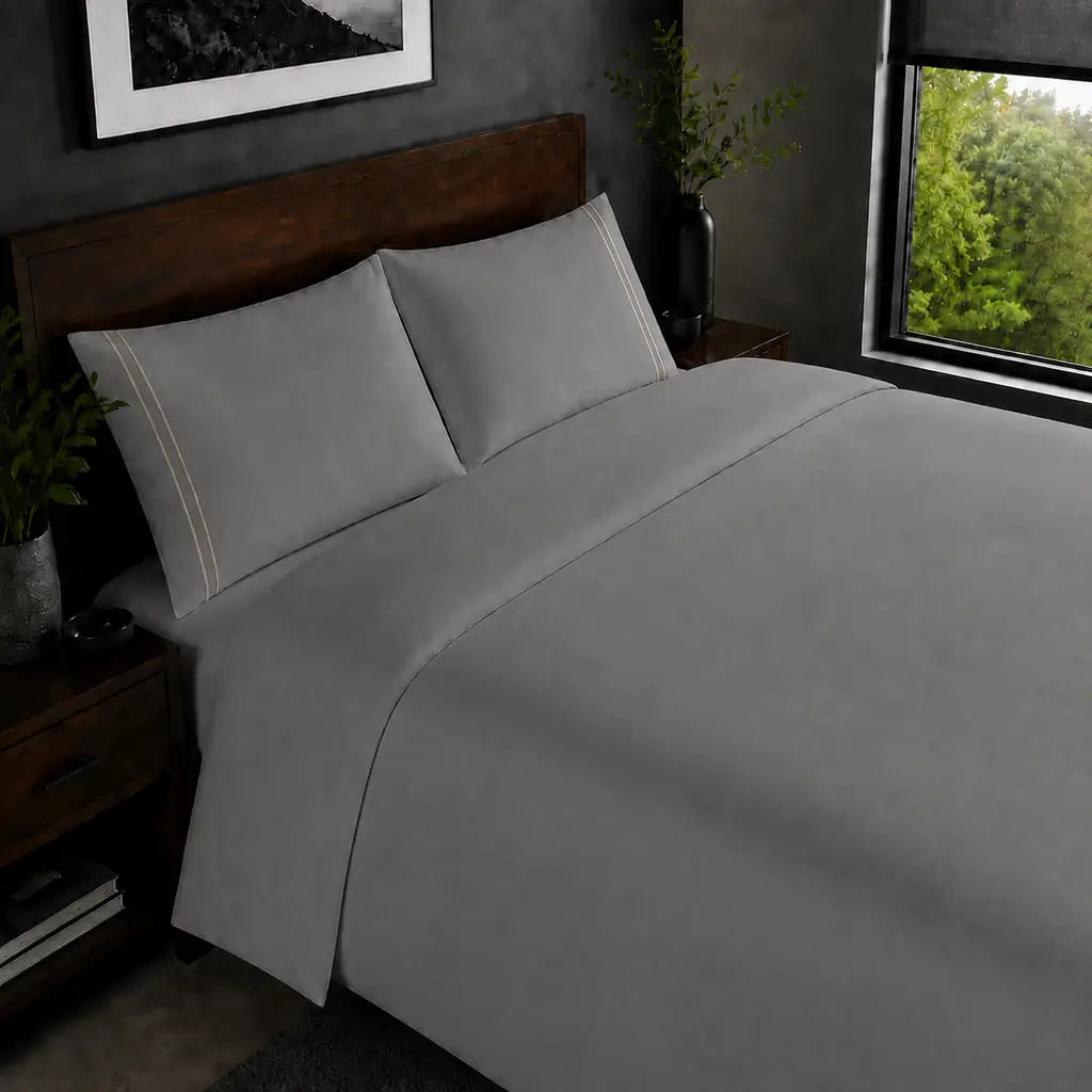Grey 200TC plain duvet cover with Stone two row satin stitch - on the bed - Linen and Co