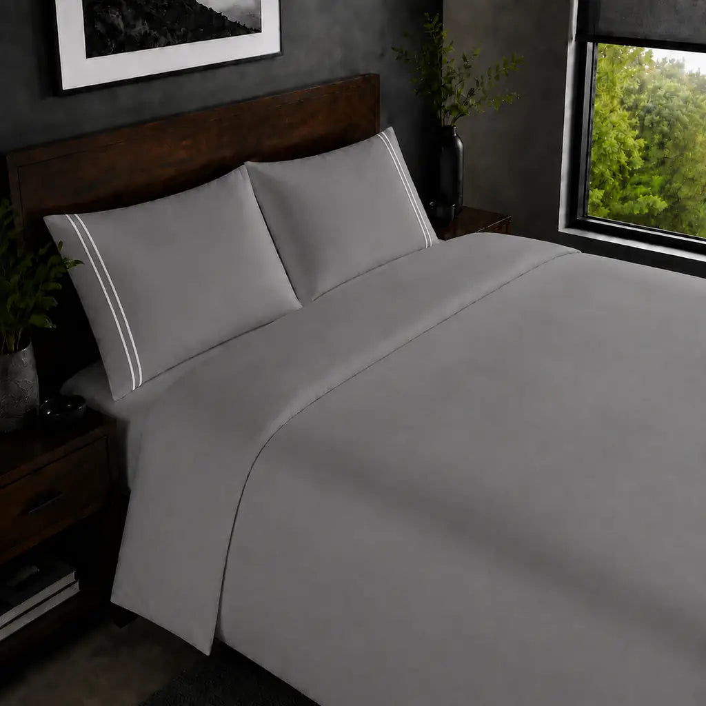 Grey 200TC plain duvet cover with White two row satin stitch - on the bed - Linen and Co