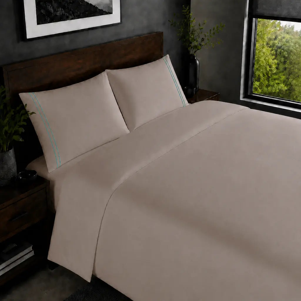 Stone 200TC plain duvet cover with Duck Egg two row satin stitch - on the bed - Linen and Co