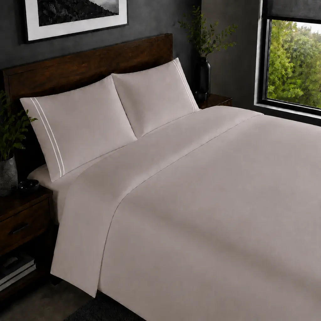 Stone 200TC plain duvet cover with White two row satin stitch - on the bed - Linen and Co
