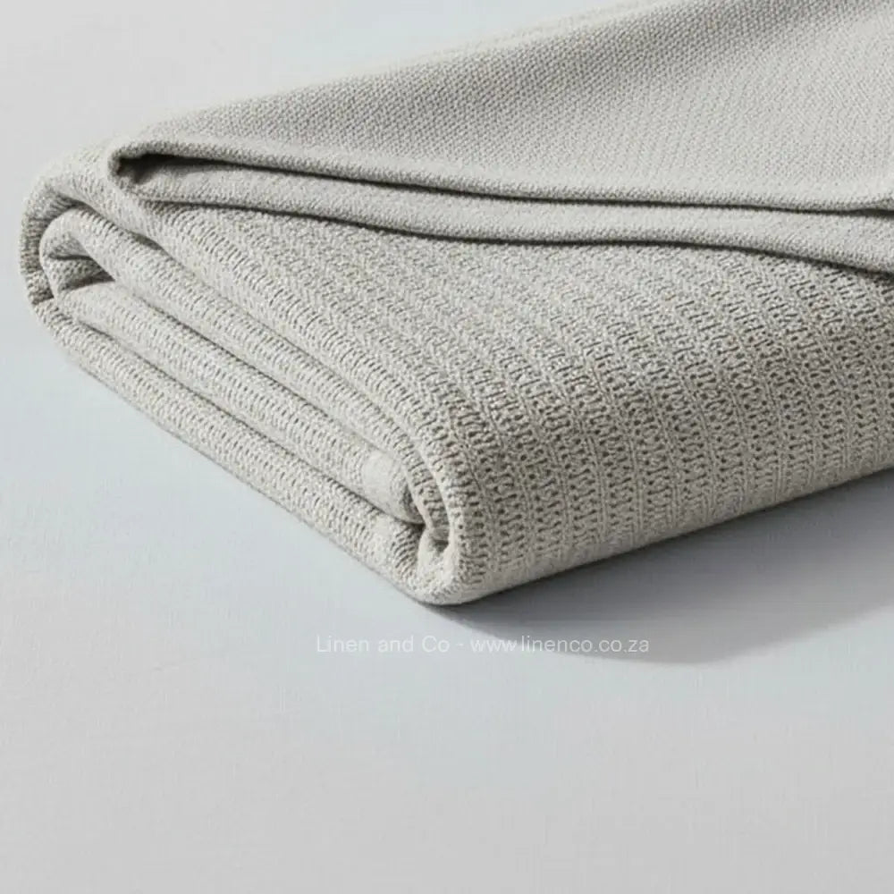 pebble cotton cellular blanket showing textured waffle weave fabric on neutral grey background—soft, breathable bedding by Linen & Co