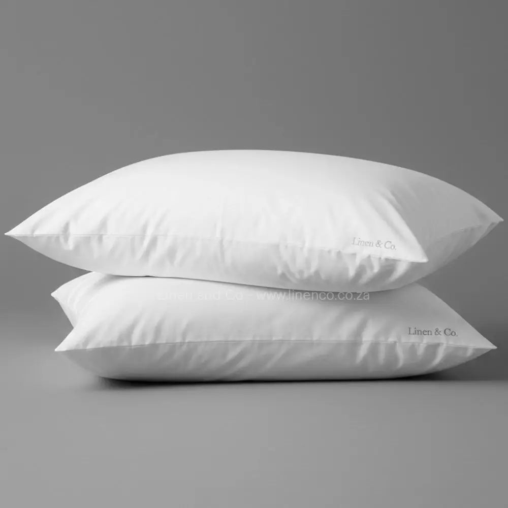 White luxury microfibre pillow from Linen and Co luxury hospitality collection, professional product photography showcasing premium pillow quality and comfort.