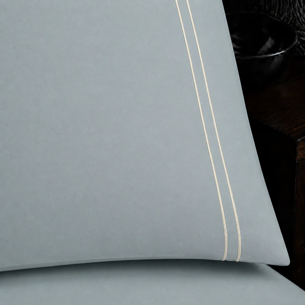 Close-up of duck egg pillowcase with two row cream satin stitch border by Linen and Co